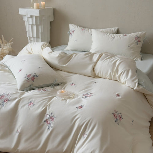 Luxurious cotton bedding set with delicate floral embroidery and reversible pillowcases