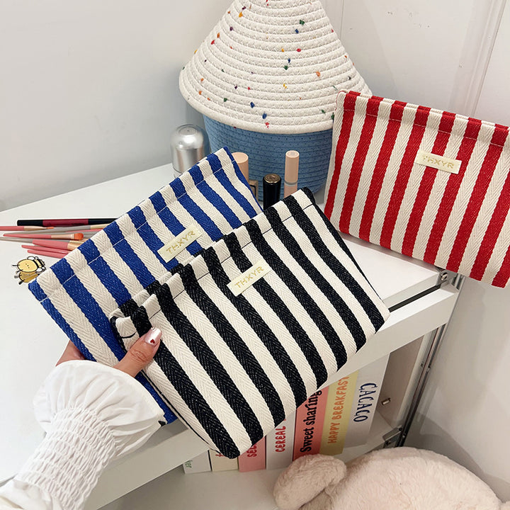 Striped canvas zippered cosmetic pouch clutch with padded lining and wristlet Bowlift