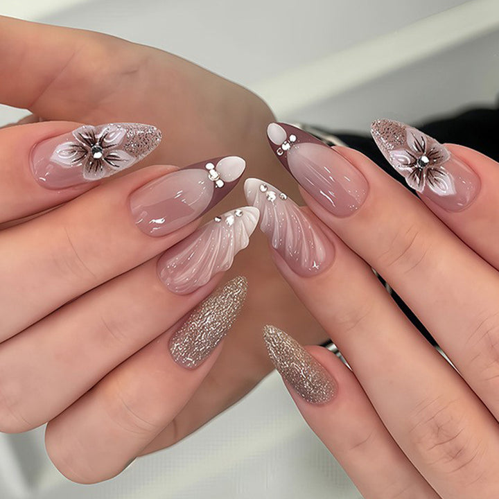 Artificial nails in elegant floral design with glitter accents Bowlift