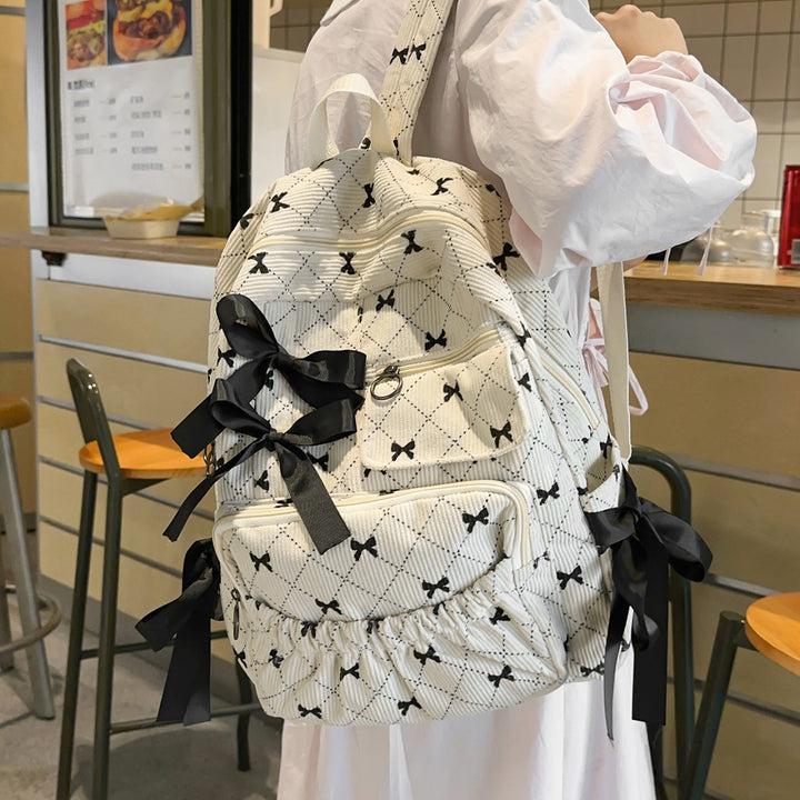 Playful backpack with bow details and practical compartments Bowlift