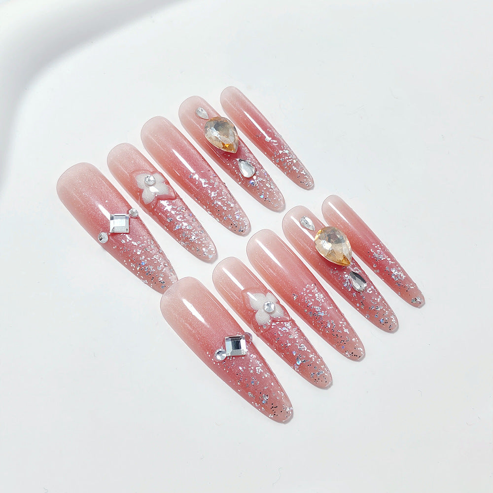 Artificial nail set with glitter and flower accents Bowlift