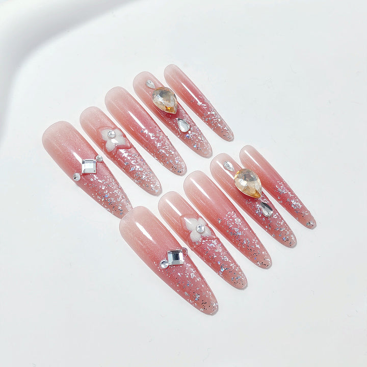 Artificial nail set with glitter and flower accents Bowlift