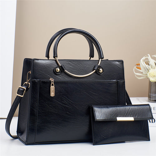 Elegant handbag with detachable shoulder strap and matching wallet Bowlift