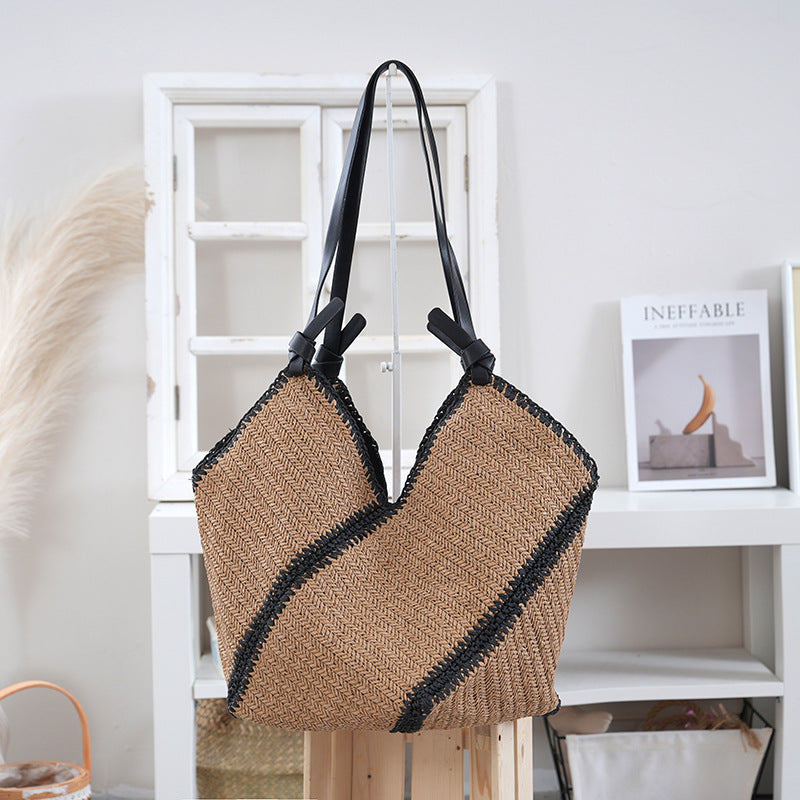 Handbag made of braided natural material with contrasting leather handles Bowlift