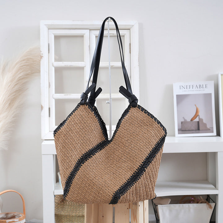Handbag made of braided natural material with contrasting leather handles Bowlift
