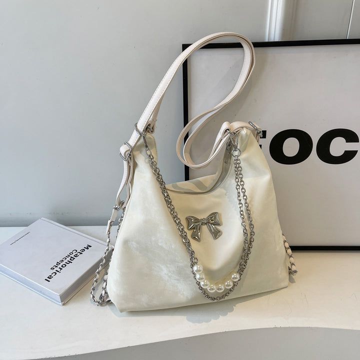 Fashionable handbag with unique pendant and chain accents Bowlift