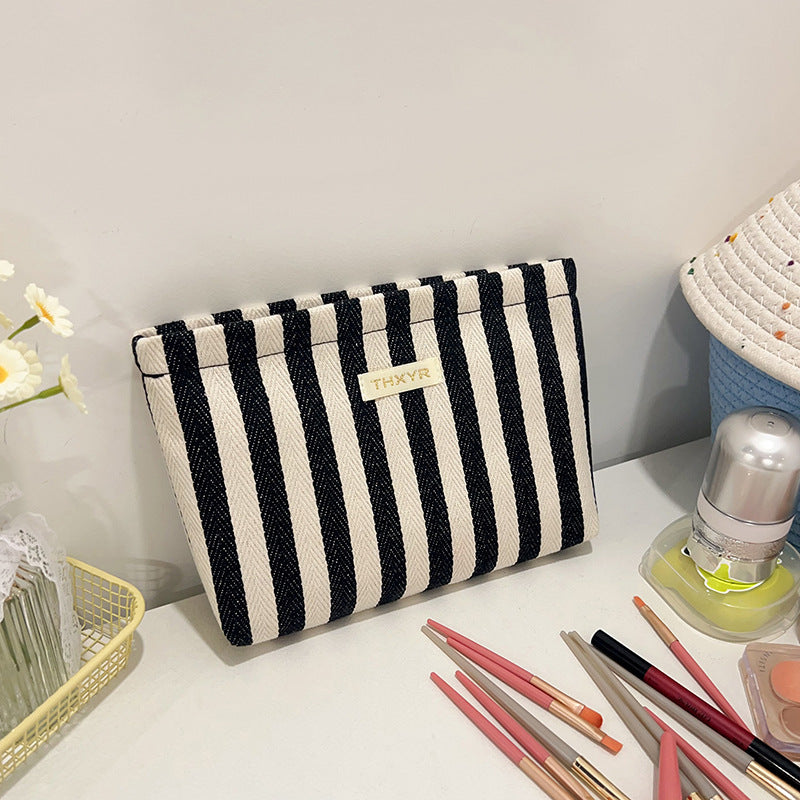 Striped canvas zippered cosmetic pouch clutch with padded lining and wristlet Bowlift