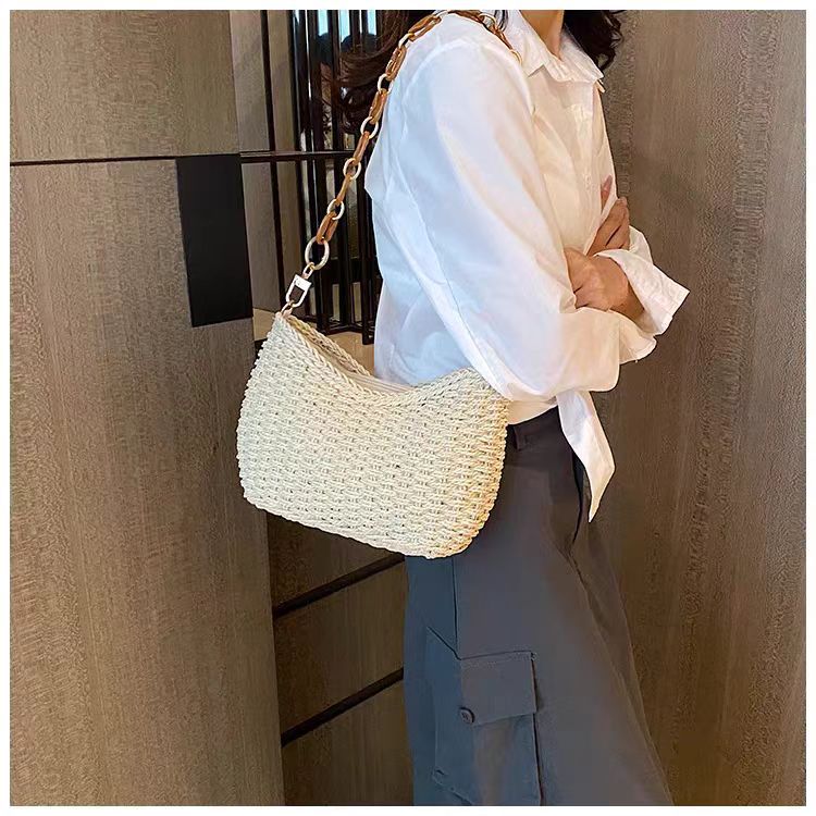 Handcrafted straw bag with golden chain details Bowlift