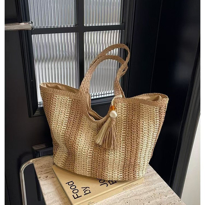 Handcrafted straw bag with elegant tassels and detailed texture Bowlift
