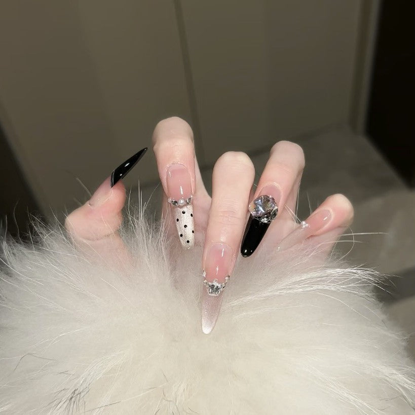 Artificial nails in elegant design with glittering decorations Bowlift
