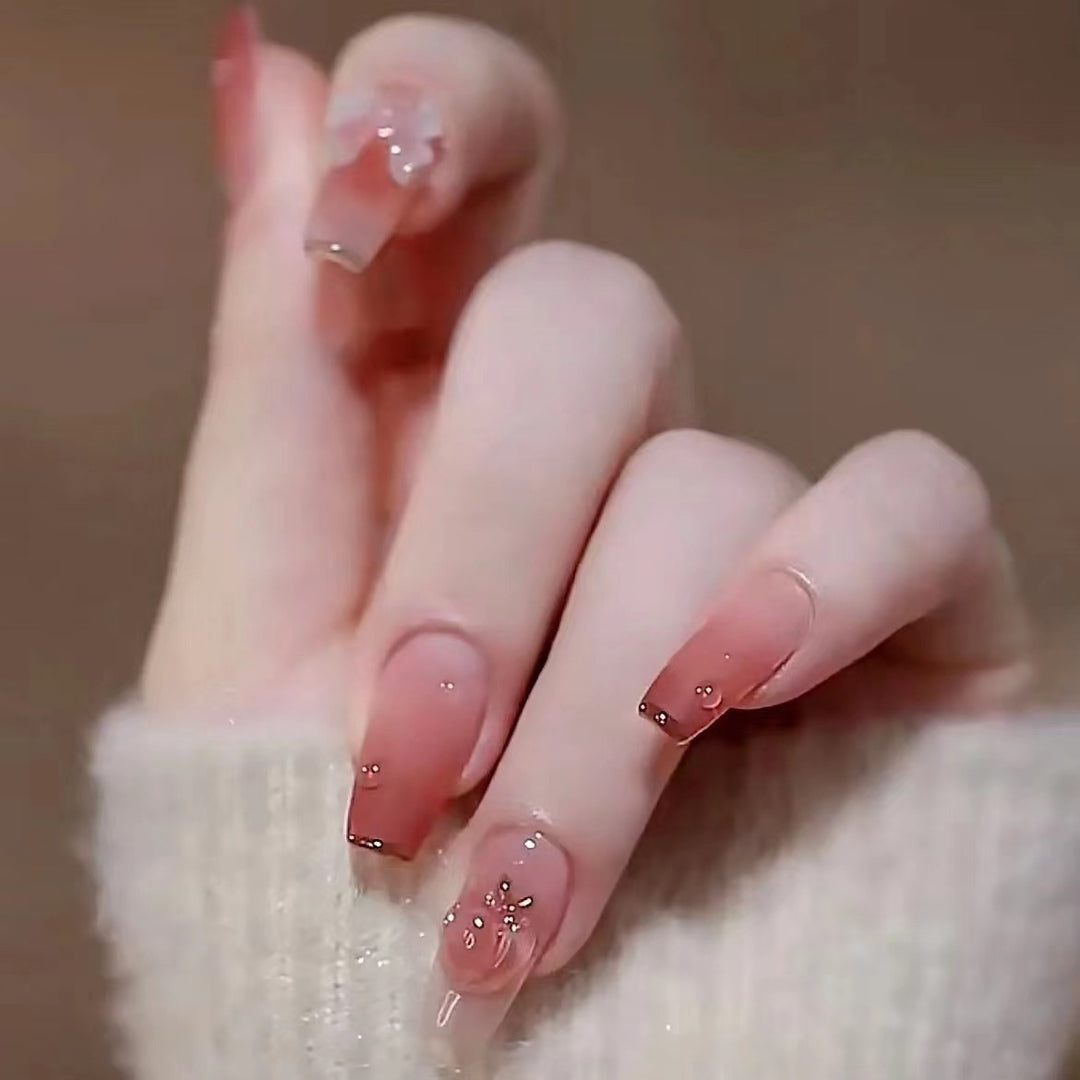 Artificial nails with floral design and glitter accents Bowlift