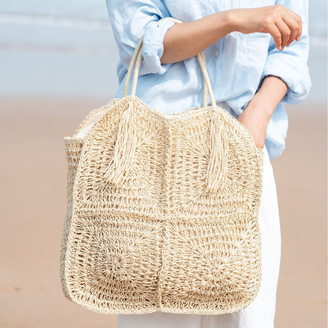Spacious handbag made of braided natural material with fringes Bowlift