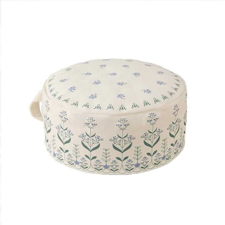 Round floor pouf with ethnic weaving pattern and practical carrying handle Bowlift