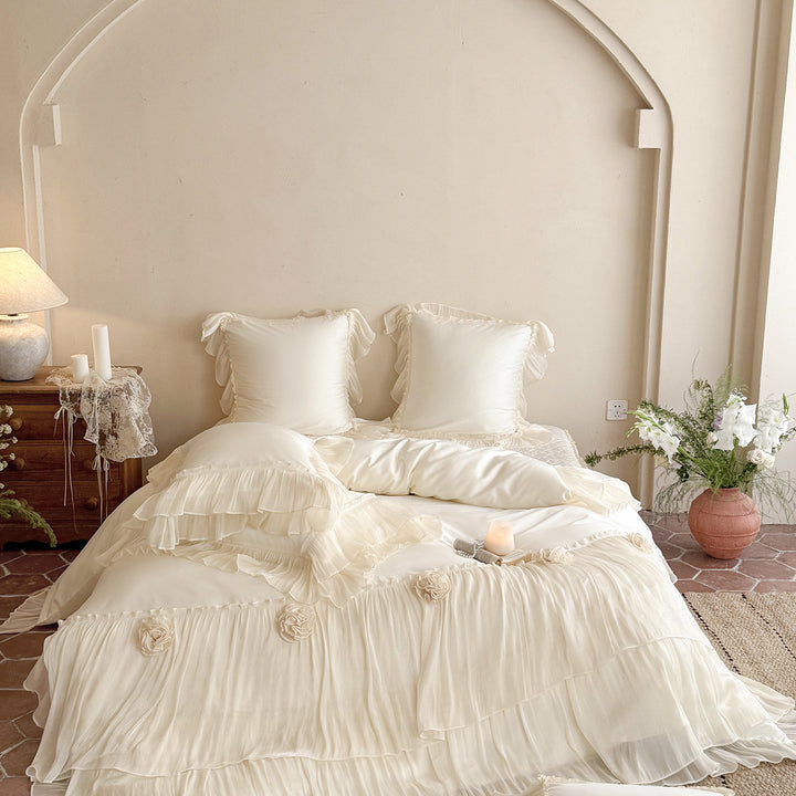 Romantic satin bedding set with layered ruffles and rose appliqués