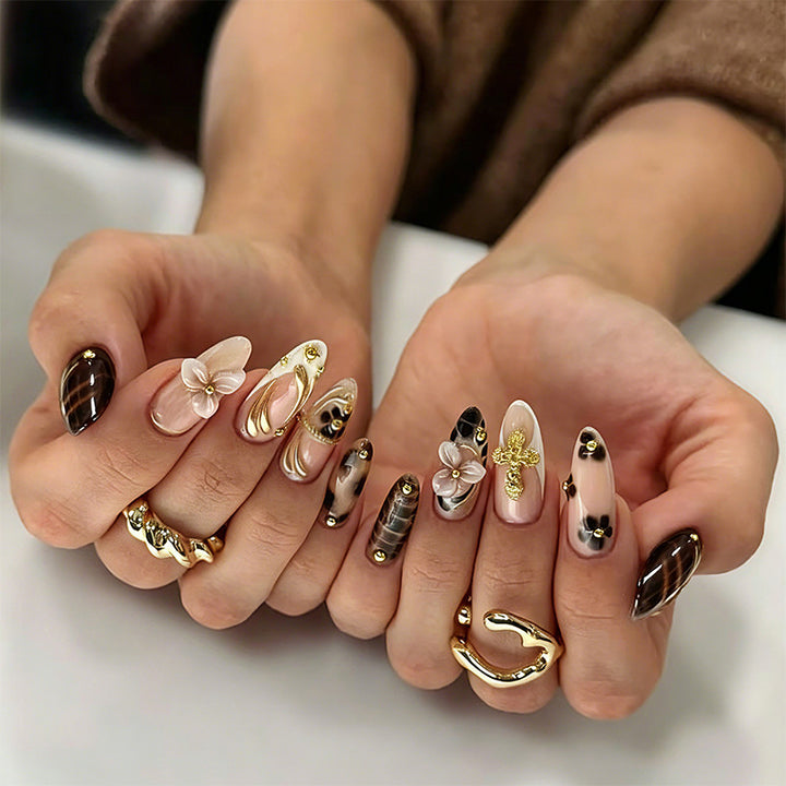 Artificial nail set with glamorous floral designs and creative glitter accents Bowlift