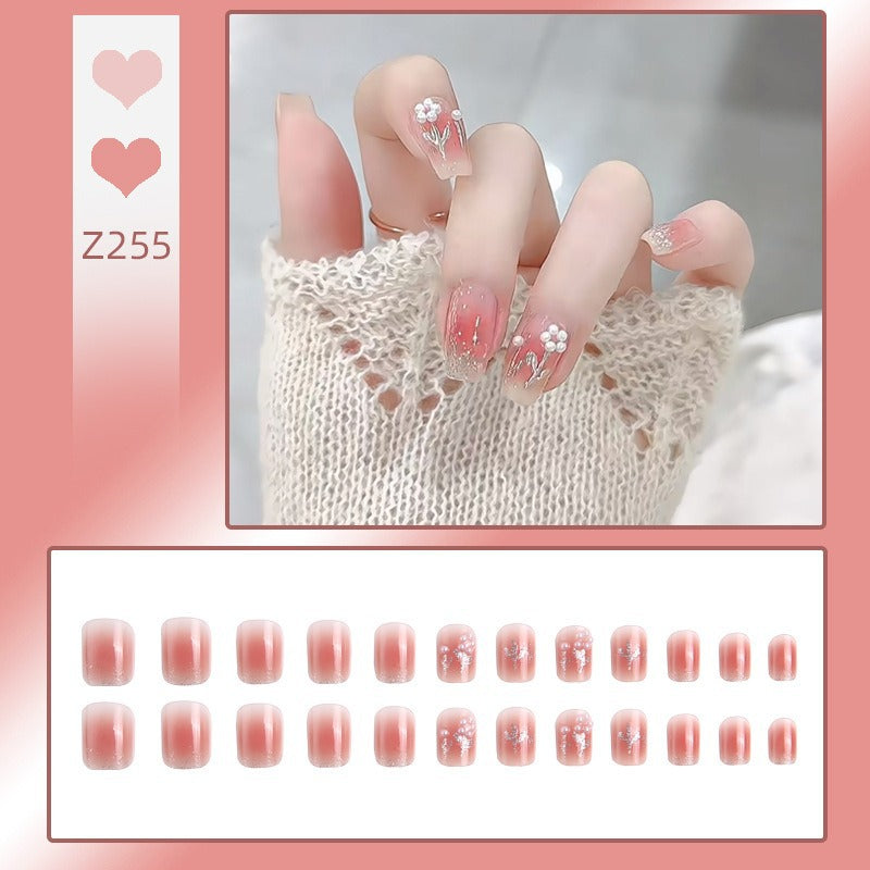 Artificial nail set with floral designs and glitter accents Bowlift