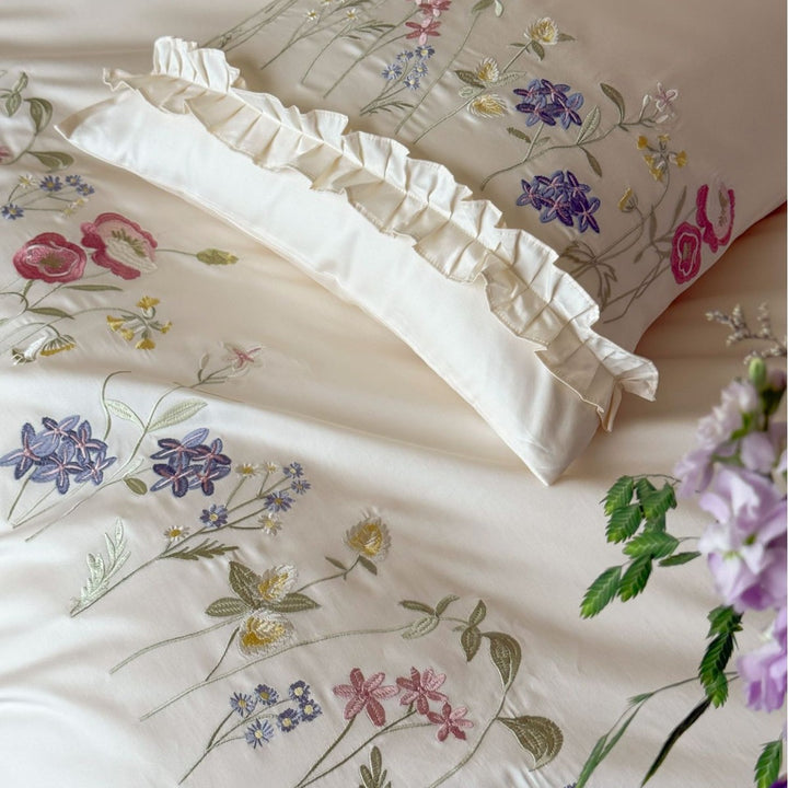 Fine satin bed linen set with delicate botanical embroidery and ruffled edge Bowlift