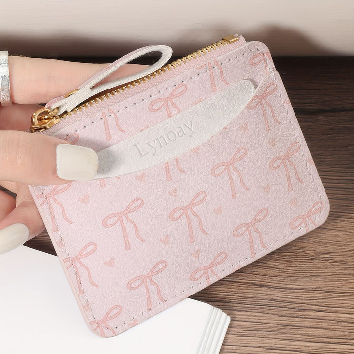 Compact bow-print coin purse wristlet with zipper closure Bowlift