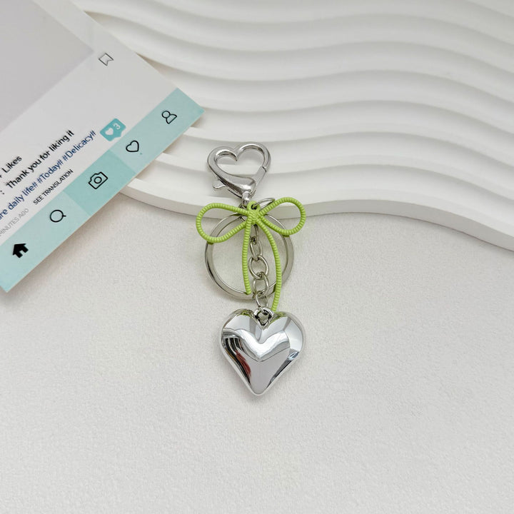 Heart-Shaped Metallic Keychain with Decorative Bow Bowlift