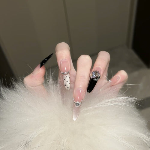Artificial nails in elegant design with glittering decorations Bowlift
