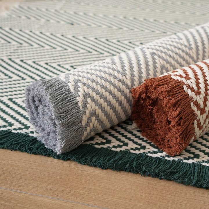Handwoven cotton bath mat with herringbone pattern and fringes Bowlift