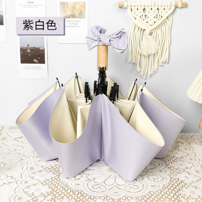 Ladies elegant folding umbrella in portrait format with stylish wooden handle Bowlift