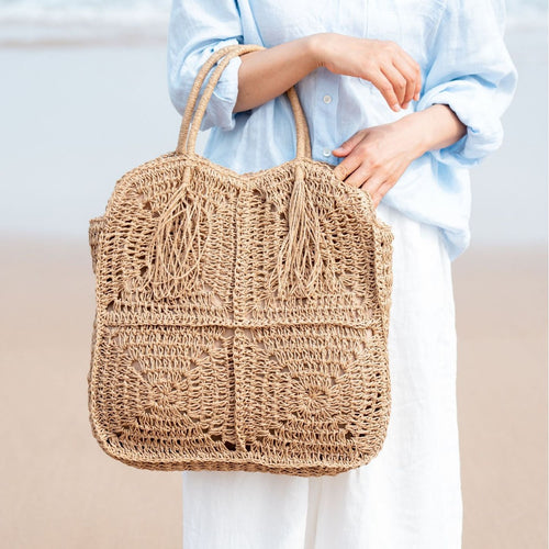 Spacious handbag made of braided natural material with fringes Bowlift