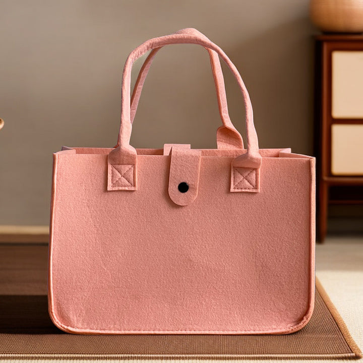 Structured felt tote bag with reinforced handles and organized interior Bowlift