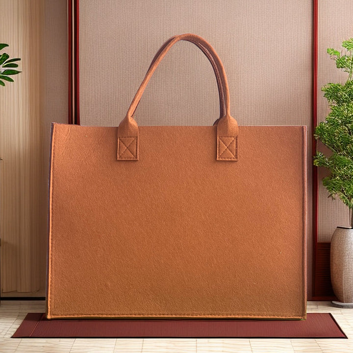 Structured felt tote bag with reinforced handles and organized interior Bowlift