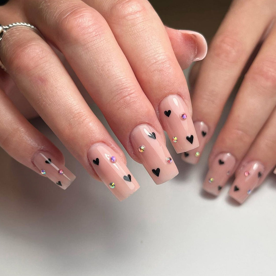 Artistic nail art with heart design and glitter accents Bowlift