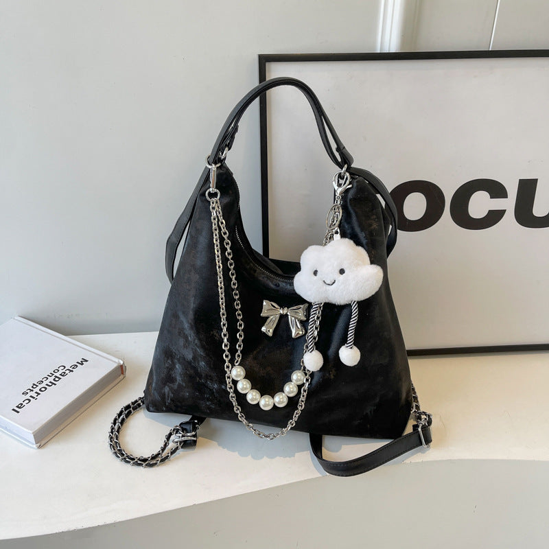 Fashionable handbag with unique pendant and chain accents Bowlift