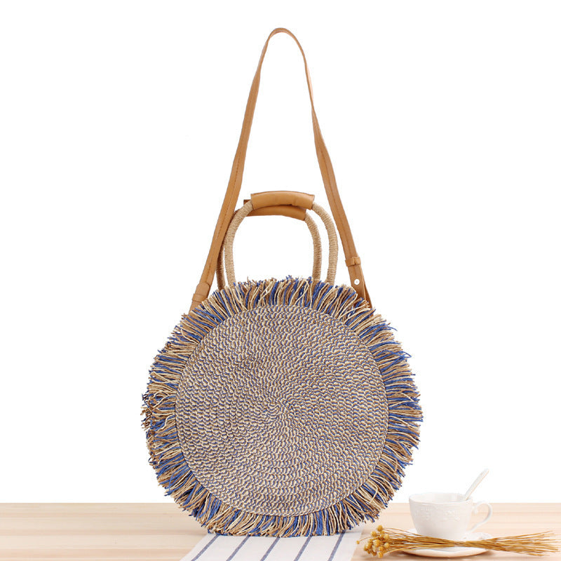 Round bag with fringe decoration Made of woven material Bowlift
