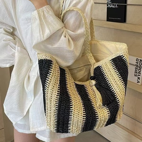 Handcrafted straw bag with elegant tassels and detailed texture Bowlift