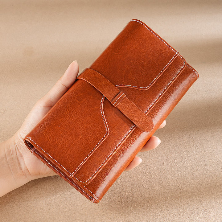 Premium leather long wallet clutch with strap closure and multiple card slots Bowlift