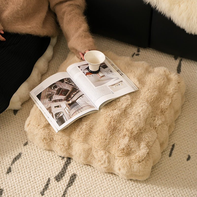 Plush floor cushion pouf with padded filling and faux fur cover
