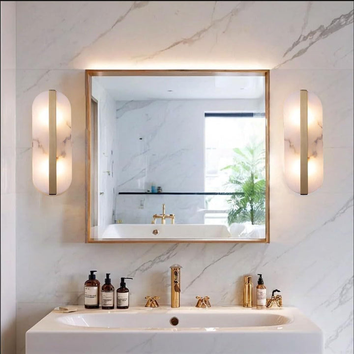 Modern marble oval wall sconce with brass accent and dual pin lamp holders Bowlift