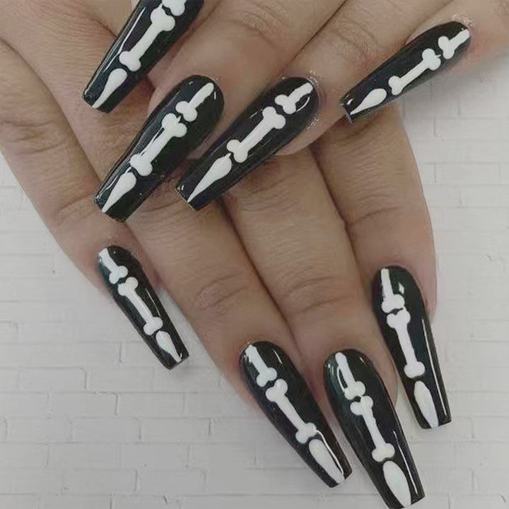 Artistic nail art with skull and bone motif Bowlift