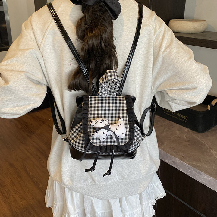 Playful backpack with checkered pattern and animal appliqué Bowlift