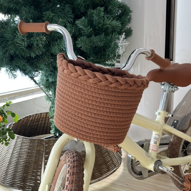 braided rope bike basket with pom pom embellishments and leather handlebar straps Bowlift