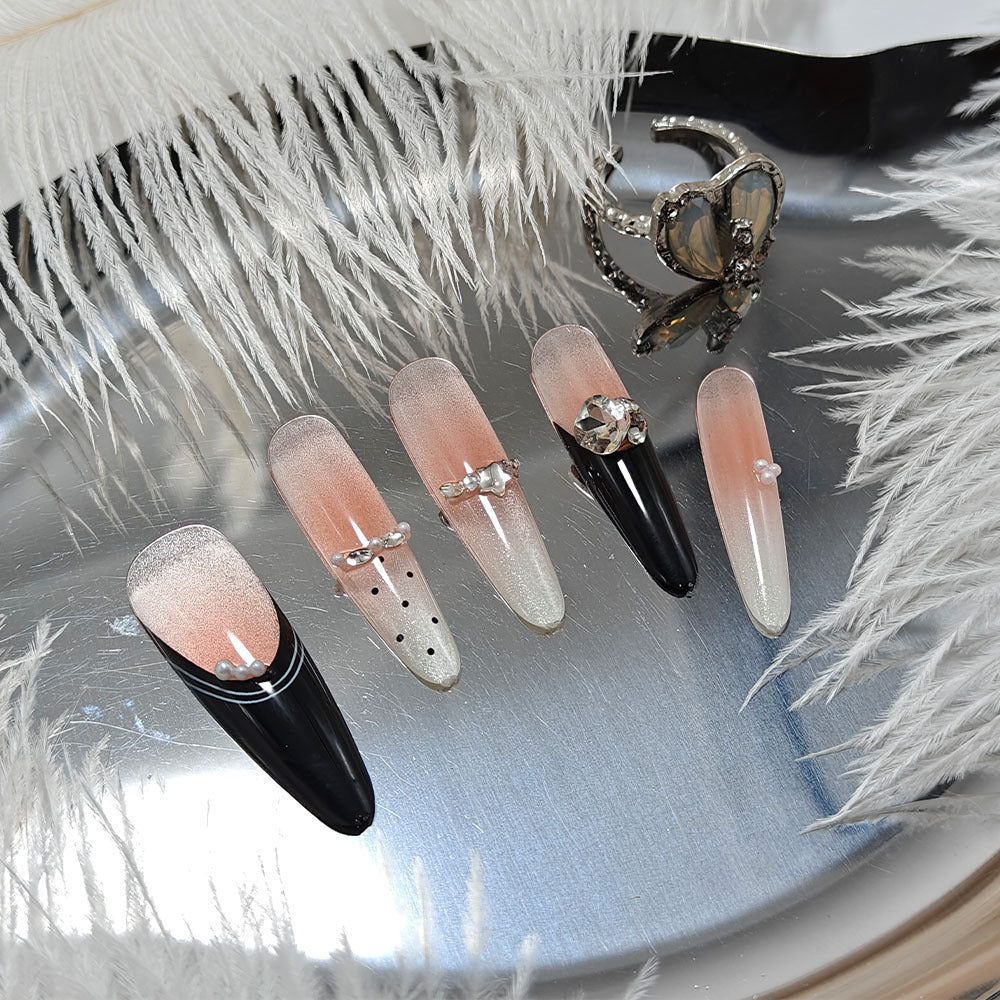 Artificial nails in elegant design with glittering decorations Bowlift