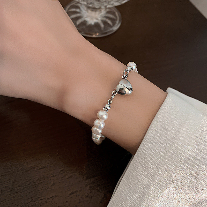 Elegant silver pearl bracelet with heart details Bowlift