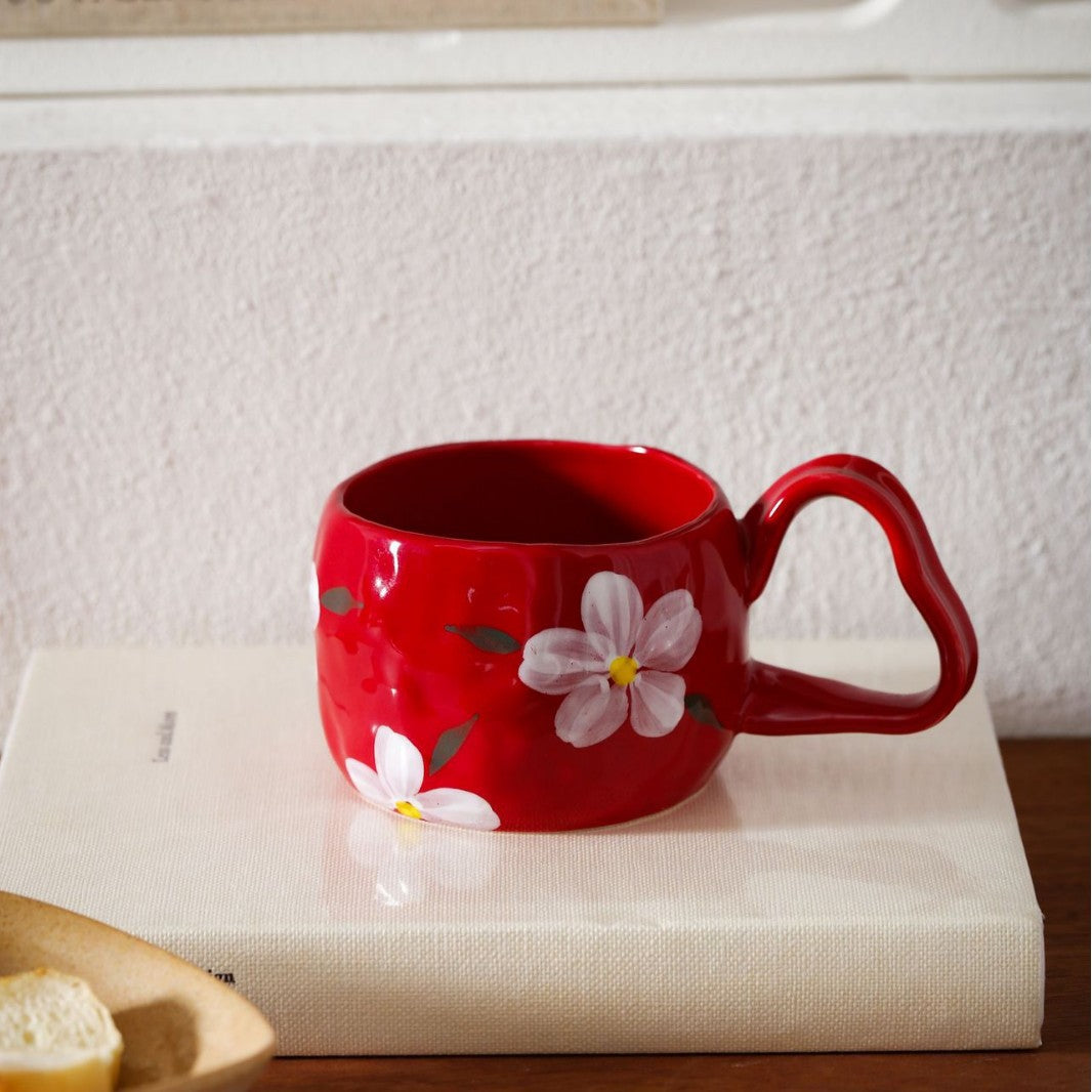 Ceramic mug with hand-painted stripes and flower design