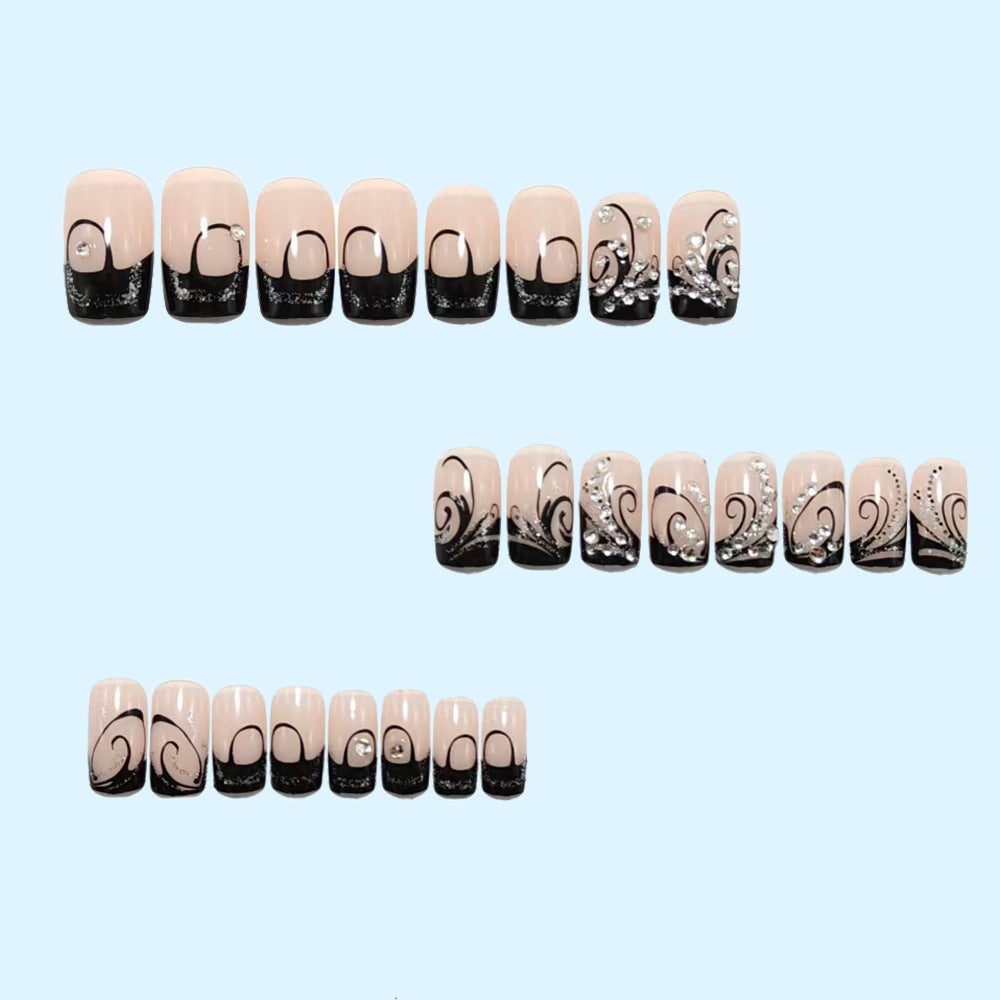 Artificial nails in elegant black-and-white design with glitter applications Bowlift