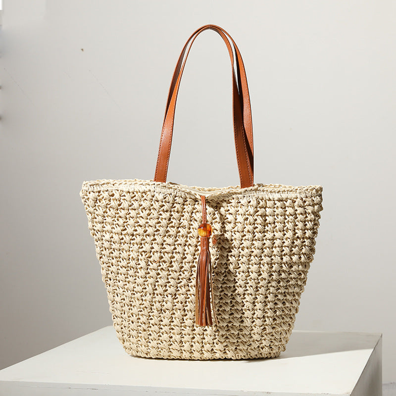Handcrafted basket bag with fashionable tassel detail Bowlift