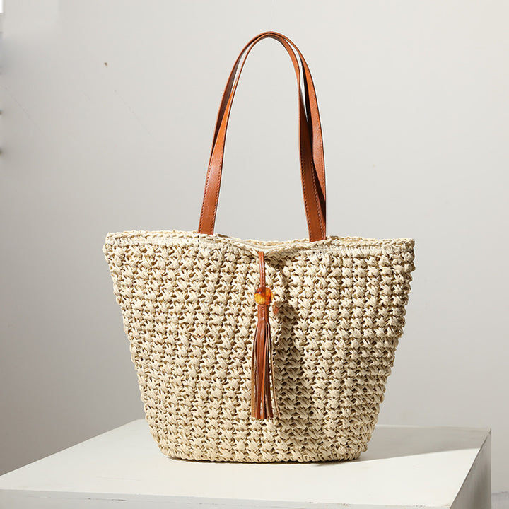 Handcrafted basket bag with fashionable tassel detail Bowlift