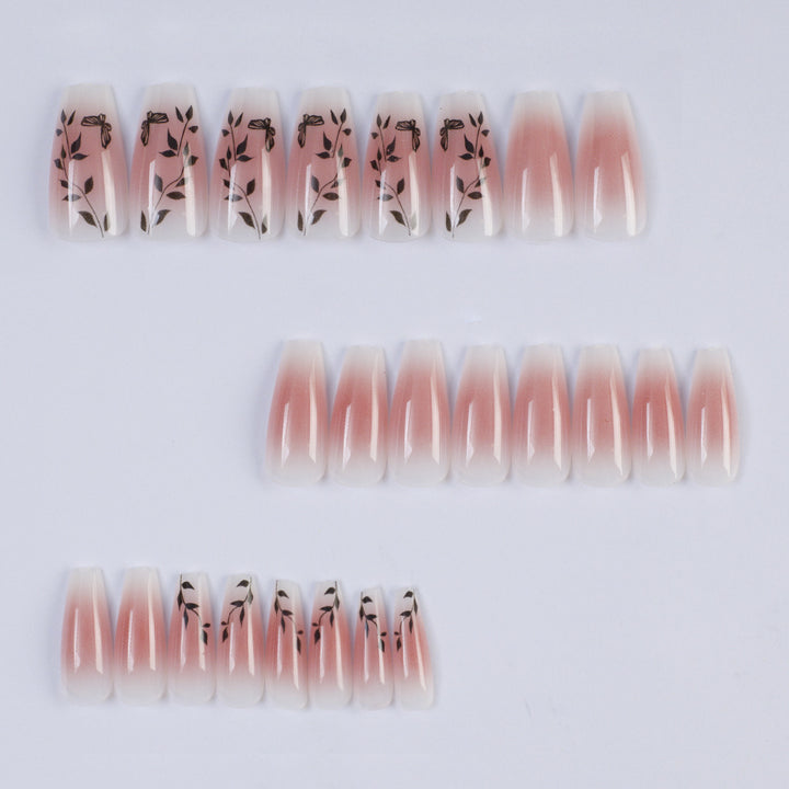 Press-on nails in elegant ombre design with floral accents Bowlift