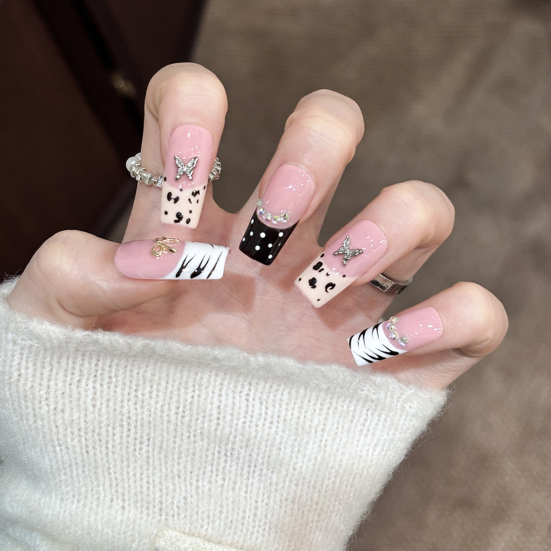 Artistic Press-On Nail Enhancements with Pattern and Gem Accents