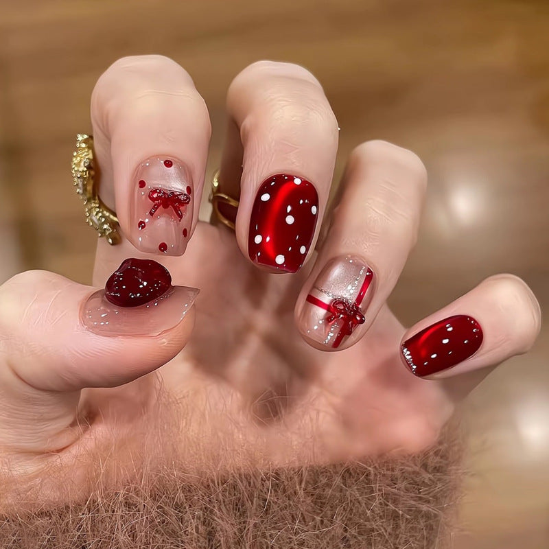 Artificial nail set with festive gift design and elegant glitter accents Bowlift