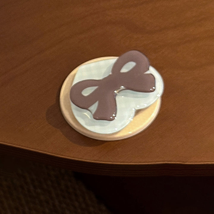 Decorative ceramic coaster with bow motif Bowlift