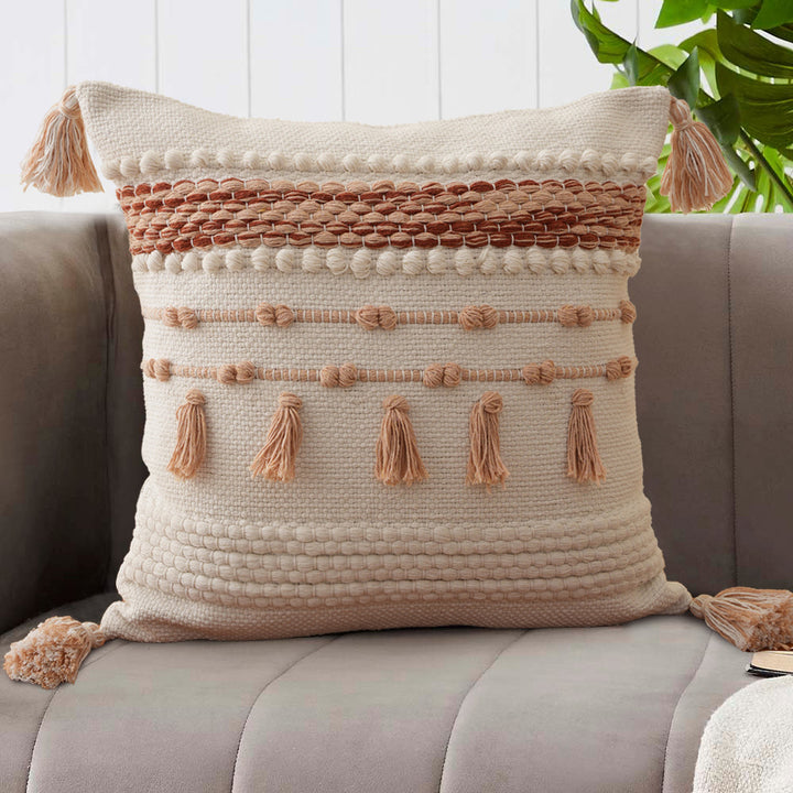 Structured decorative pillow with tufted diamonds, relief border, and corner tassels